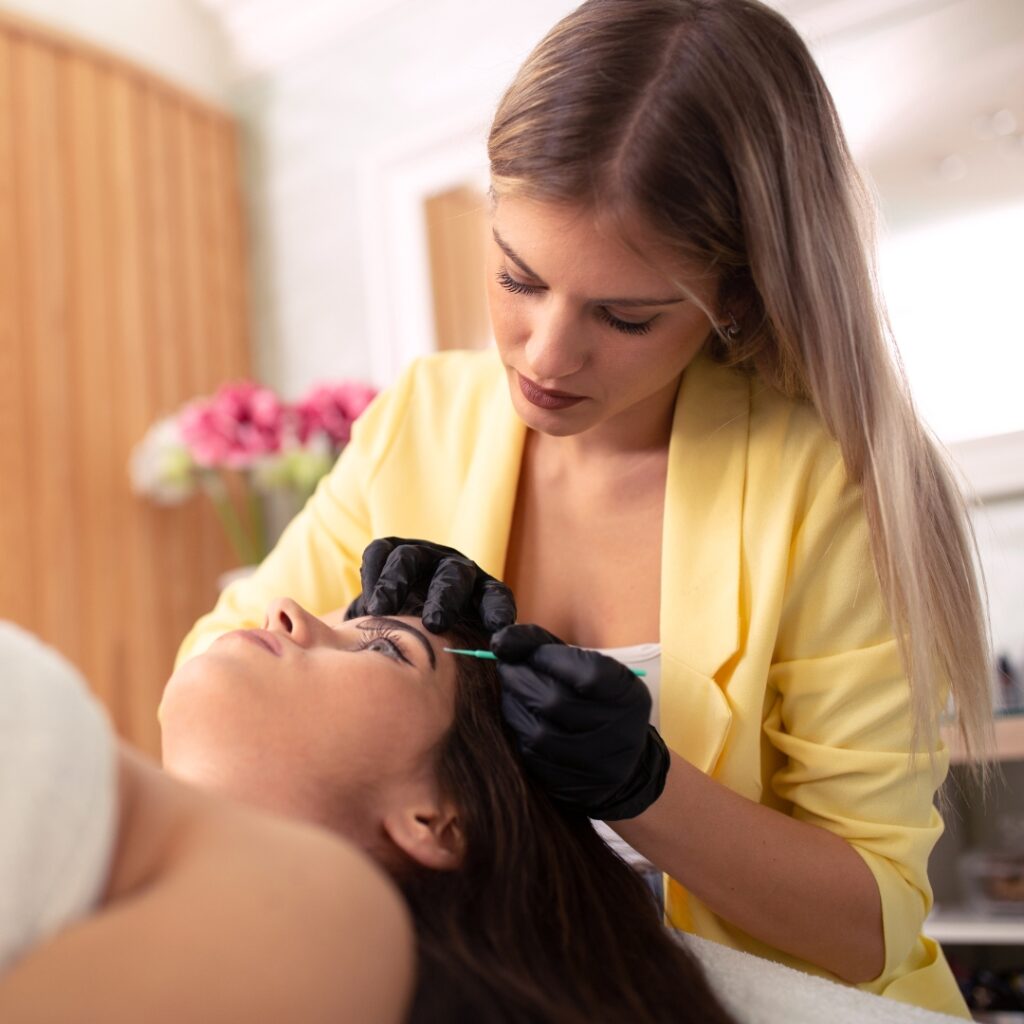 Esthetician giving a woman a facial