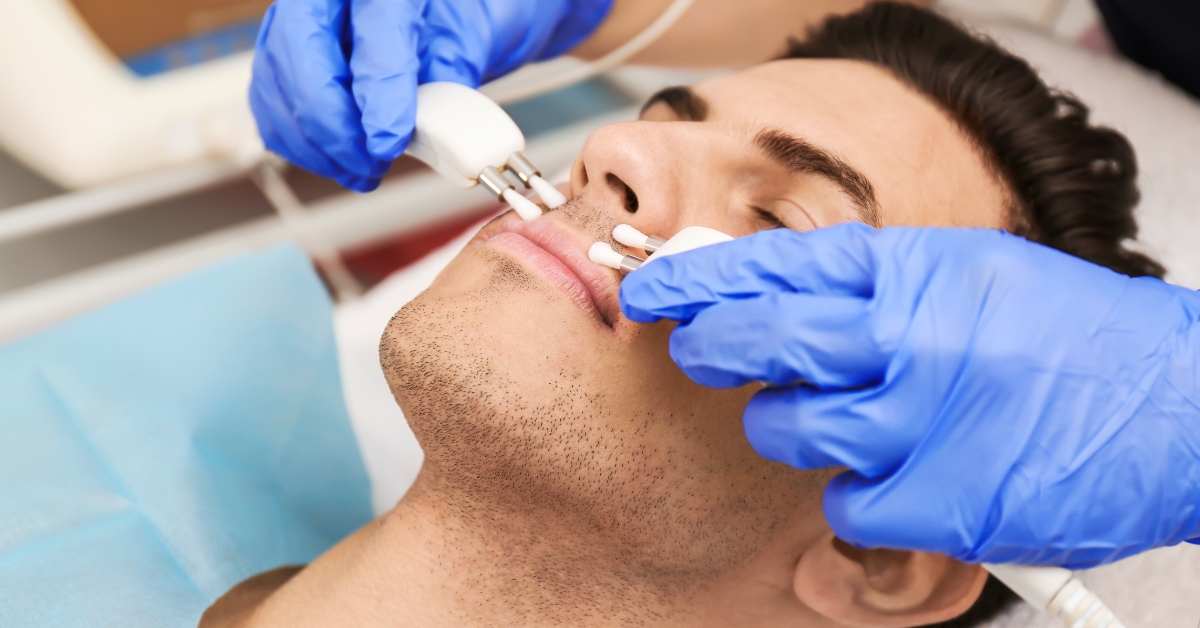 man receiving microcurrent facial